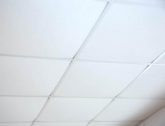 Can you drywall over asbestos ceiling tiles? 