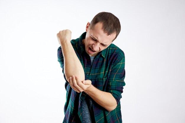 Why do I get a sharp pain in my elbow when I lean on it? 